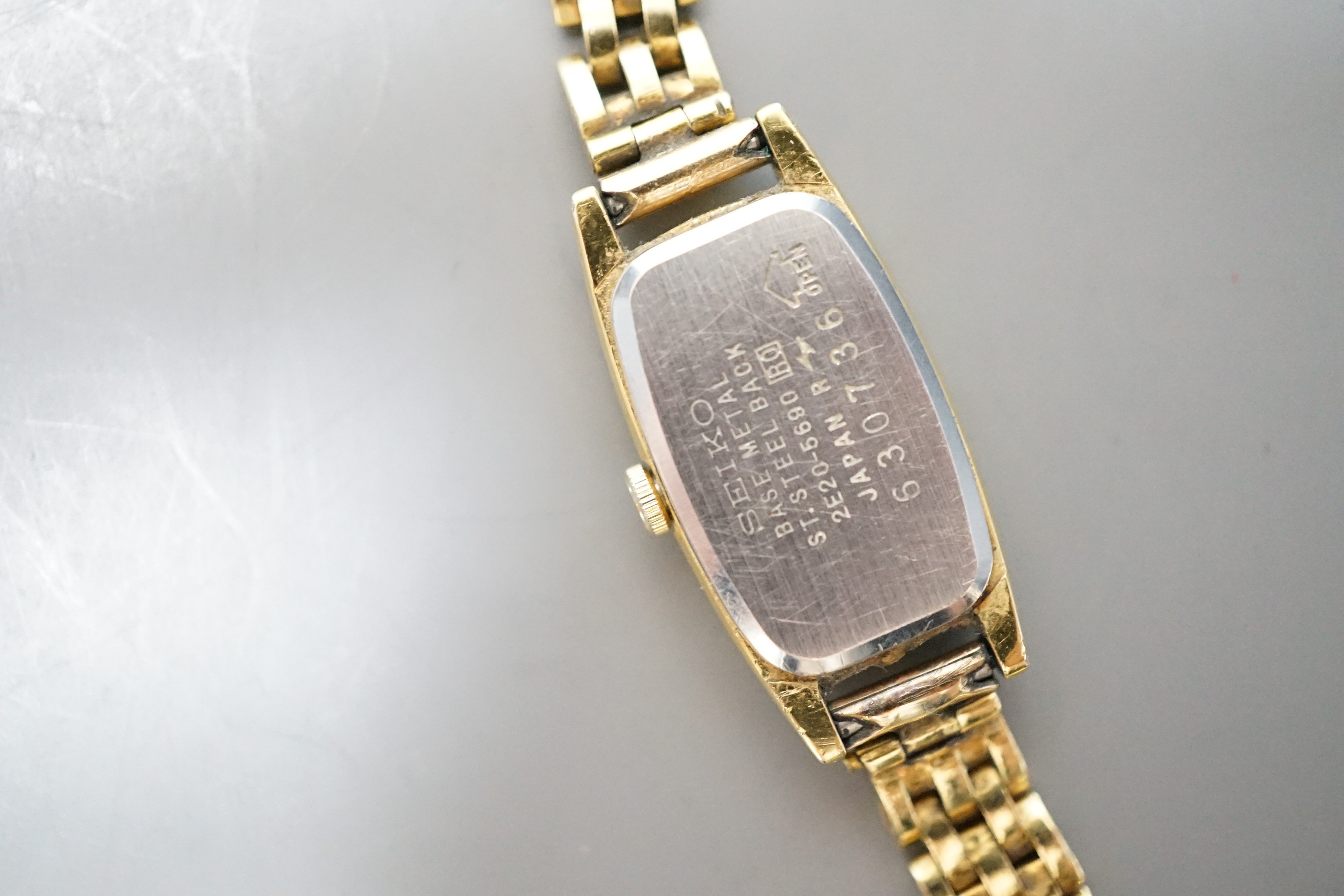 A lady's steel and gold plated Seiko quartz wrist watch, on an 18ct gold bracelet